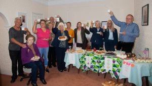 Visitors to Macmillan coffee morning with funeral staff and funeral celebrant